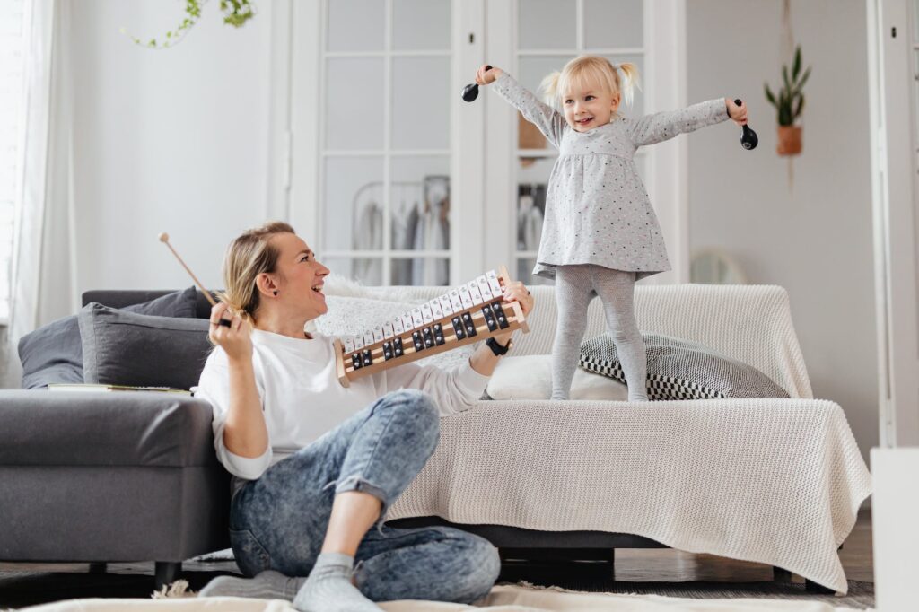 mother and daughter having fun and playing instruments