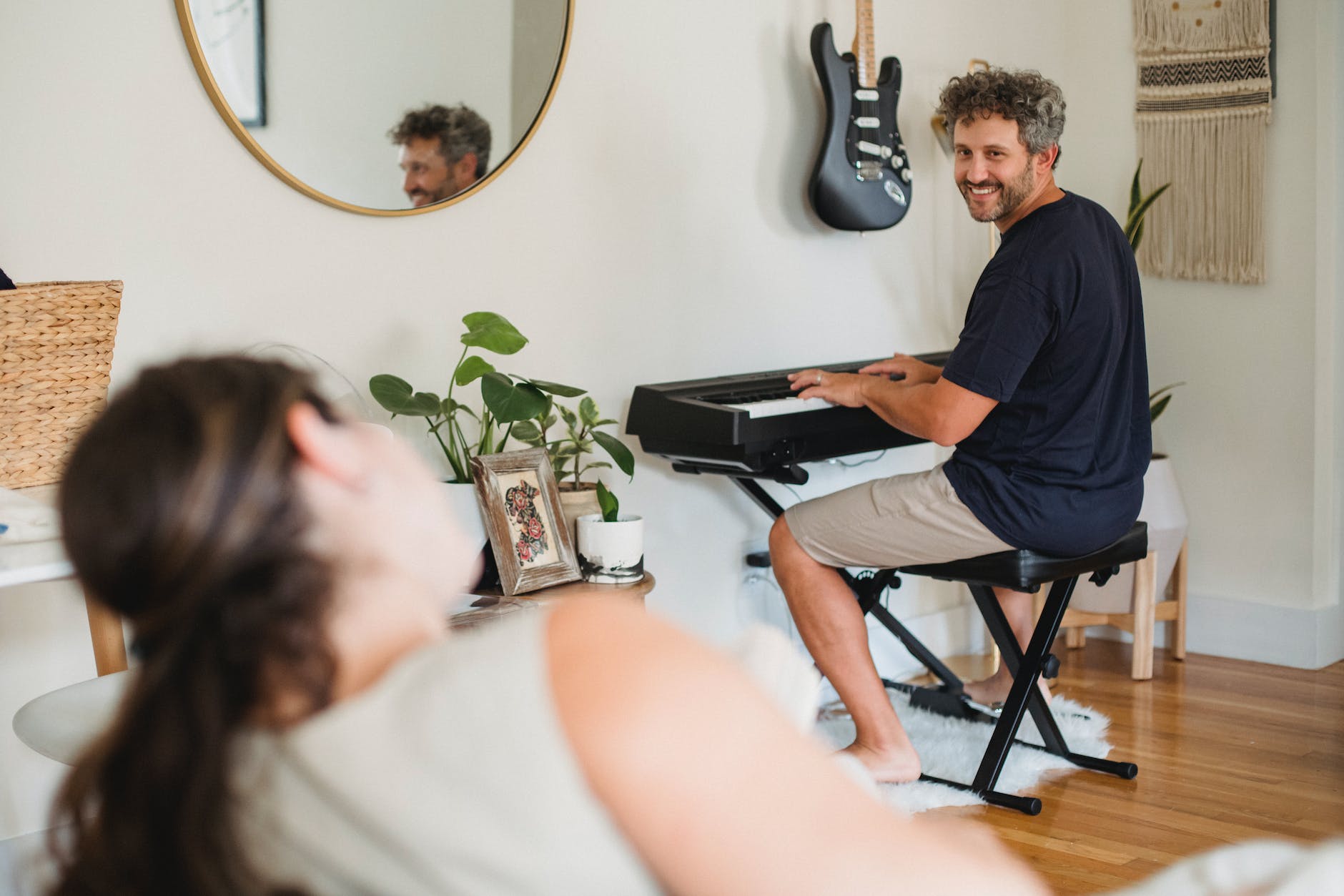 adult man playing piano for wife at home